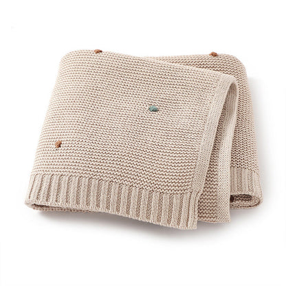 Knitted Solid Color Baby Blanket With Hand-Embroidered Pom Poms