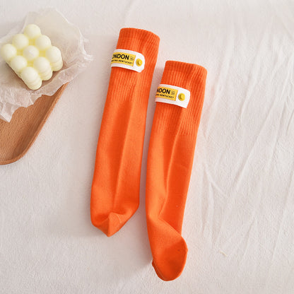Kids Solid Middle Tube With Trendy Cloth Label Design Socks