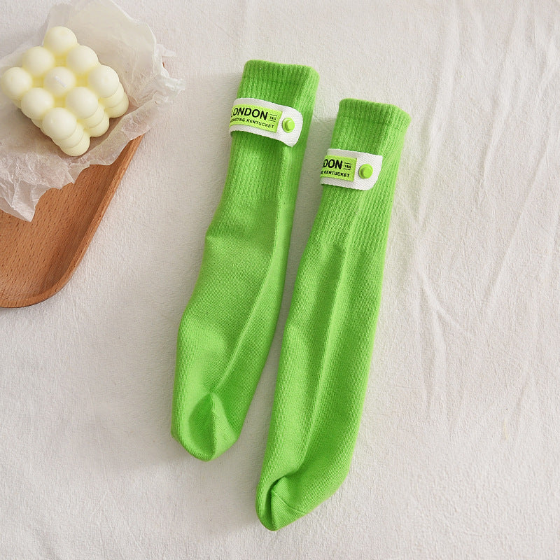 Kids Solid Middle Tube With Trendy Cloth Label Design Socks